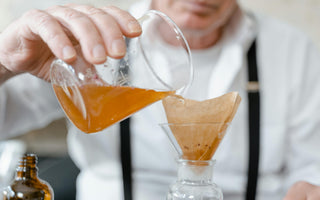 Man Filtering Media Through a Paper Filter 