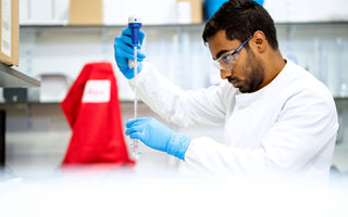 Man In Lab Using Serological Pipette to Dispense Liquids into Centrifuge tube